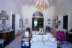 a living room filled with furniture and a chandelier