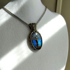 Discover the beauty of our unique Tree of Life pendant, meticulously handcrafted with care and attention to detail. This enchanting necklace features a stunning blue Labradorite stone, elegantly wrapped in German silver wire with a brass Tree of Life design. **What Makes This Pendant Special - **Handmade Craftsmanship Each pendant is entirely handcrafted, ensuring a one-of-a-kind piece. - **Spiritual Symbolism The Tree of Life design symbolizes growth, strength, and connection, making it a meaningful gift. - **Quality Materials Made with German silver wire and brass, paired with a striking blue Labradorite stone known for its mystical and protective qualities. - **Versatile Style The pendant comes with a steel chain, making it a versatile addition to any jewelry collection. **Product Detai Nickel Free Labradorite Jewelry As Gift, Nickel Free Labradorite Jewelry For Gift, Nickel-free Labradorite Jewelry As Gift, Blue Engraved Necklace For Gift, Blue Engraved Jewelry For Gift, Sapphire Cabochon Jewelry For Gifting, Sapphire Cabochon Jewelry As A Gift, Sapphire Cabochon Jewelry For Gift, Labradorite Blue Necklace As Gift