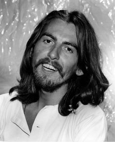 a black and white photo of a man with long hair