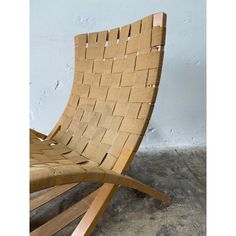 a wooden chair sitting on top of a cement floor