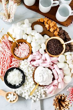 a platter filled with marshmallows, chocolate and candy