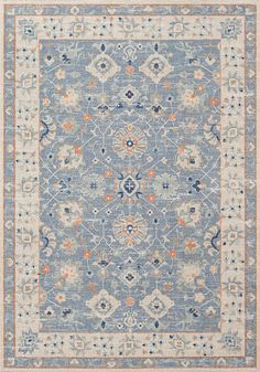 a blue rug with an orange and white design on the bottom, in front of a gray background