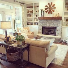 a living room filled with furniture and a fire place