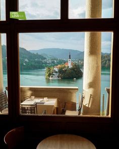 the view from inside a restaurant looking out onto a lake