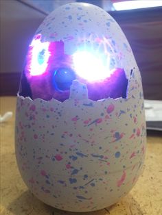 an egg with some lights in it sitting on a table