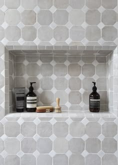 a shelf with some bottles and soaps on it next to a wall that says luxurious shower niche