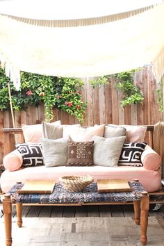 a couch sitting on top of a wooden floor next to a white canopy over it