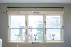 a window with measurements for the height of it in front of a wall and ceiling