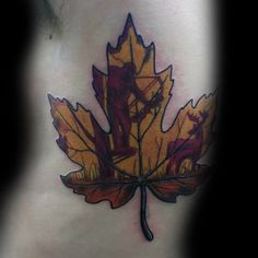 a leaf tattoo on the back of a woman's stomach