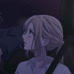 two people sitting in a car, one with blonde hair and the other with blue eyes