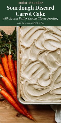 carrot cake with cream cheese frosting in a pan on top of a wooden table