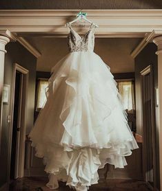 a wedding dress hanging from the ceiling