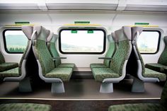 the interior of a train with green seats