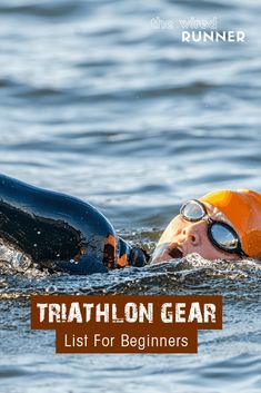 a man swimming in the water with an orange and black goggles on his head