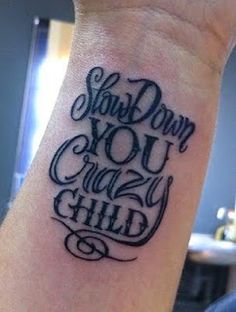 a wrist tattoo with the words show down you crazy child on it