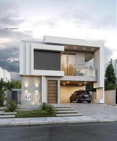 a car is parked in front of a modern house with an attached garage and balcony