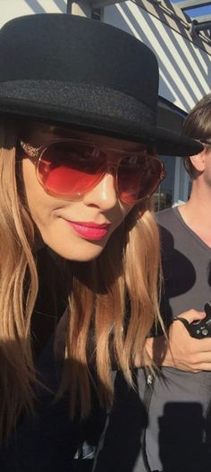 a woman wearing sunglasses and a hat