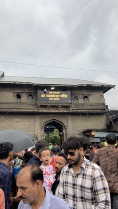 many people are standing in front of an old building