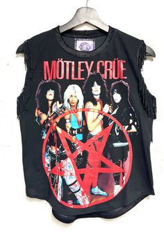 One of a kind Motley Crüe womens top. Black fringe detailing in the armholes and back.  Faux stretch black sealskin collar and back. Relaxed fit.  Size Medium  Bust- 36-38 inch circumference  Length-23 inches long Grunge Sleeveless Top For Club, Sleeveless Tops For Club In Fall, Rocker Style Top For Night Out, Alternative Sleeveless Tops For Night Out, Alternative Style Sleeveless Tops For Night Out, Club Top With Fringe, Punk Sleeveless Tops For Fall, Fitted Crew Neck Rocker Tops, Fitted Rocker Crew Neck Tops