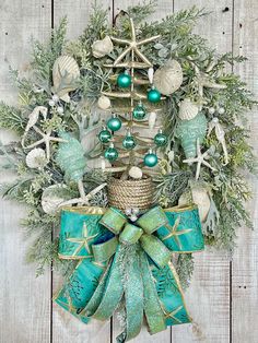 a wreath with green and white ornaments on it