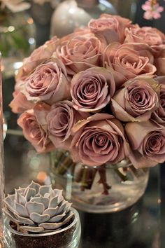 a vase filled with pink roses on top of a table