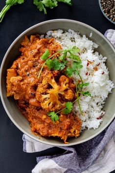 a bowl filled with rice and meat on top of a table