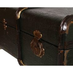 an old trunk is sitting on the ground with brass handles and knobs in front of it