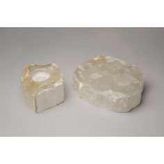 two pieces of white rock sitting next to each other