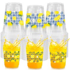 four plastic cups with lemons and orange slices in them, all stacked on top of each other