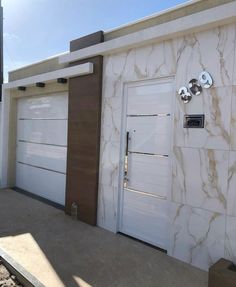 two white garage doors in front of a building