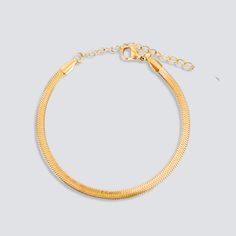 DESCRIPTION & DETAILS This dainty snake chain bracelet is glowing in rich gold, which gives a chic and delicate understated romantic look. A cute style to mix and match for your necklace layering or just on its own. Plating: 14k Gold Materials: 14K Gold on Stainless Steel Measurements: 16 + 5 cm extender Hypoallergenic SUSTAINABILITYIn-house plating - All pieces are hand crafted by our in-house jewellers ensuring a high standard of working conditions.Fair pricing - Due to our ethical manufacturi Gold Snake Chain, Snake Chain Bracelets, Necklace Layering, Romantic Look, Gold Snake, Cute Style, Recycled Sterling Silver, Snake Chain, Gold Material