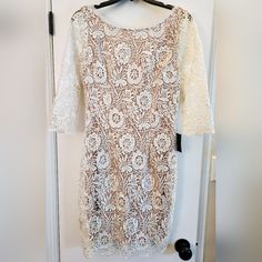 White Lace Style Dress. Tan Lining Underneath. Low Cut Back Neck Line. Sleeves Do Not Have Lining. Bought For My Wedding And Never Worn. Top To Bottom Lenght: 37" Sleeve Length: 17" Armpit To Armpit: 17" Off White Lace Mini Dress For Wedding, White Sheath Lace Dress For Evening, Elegant Off-white Lace Dress For Party, Elegant Off White Lace Dress For Parties, Fitted Off-white Lace Dress For Party, Fitted Off-white Lace Party Dress, Fitted Off White Lace Dress For Party, Off White Fitted Lace Dress For Party, White Sheath Lace Dress For Spring