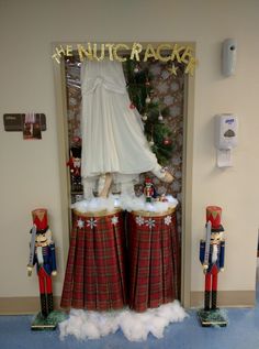 the nutcrackers are dressed in red and green tartan skirts with white fur