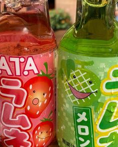 two bottles of soda sitting on top of a table