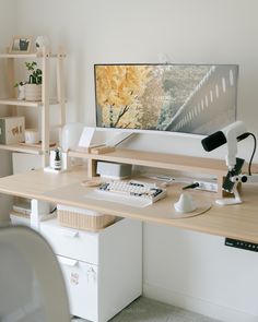 a desk with a computer monitor, keyboard and mouse sitting on it's side