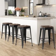 four stools in front of a kitchen island