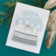 a christmas card with a snow globe on it