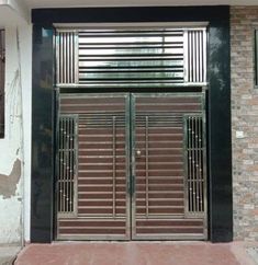 an entrance to a building with metal bars on the doors