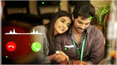 a man and woman sitting next to each other looking at a cell phone with green lights on it