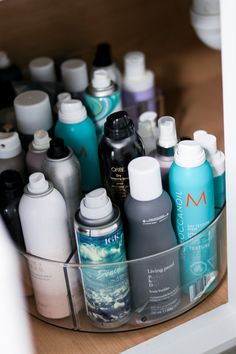 the container is filled with many different types of hair care products and shampoos