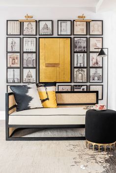 a living room filled with furniture and framed pictures on the wall above it's couch