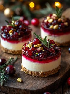 three cheesecakes with cranberry sauce and nuts on a wooden cutting board