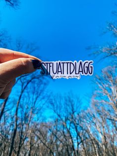 someone holding up a sticker with the word staudtlagg on it