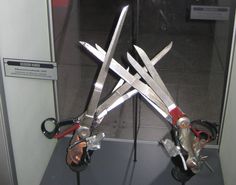 two pairs of scissors are on display in a glass case