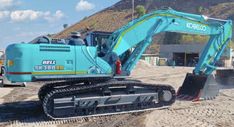 an excavator is parked in the dirt