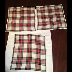 three pieces of plaid fabric laid out on top of a wooden floor next to each other