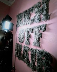 a pink wall with some letters on it