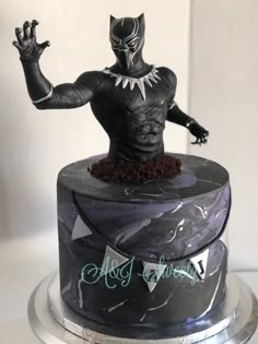 a black panther cake on top of a silver plate