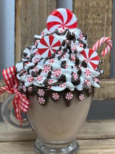 an ice cream sundae with candy canes and marshmallows on top