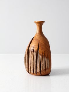 a wooden vase sitting on top of a white table